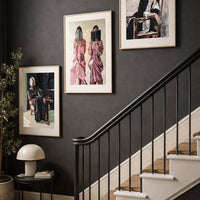 Limited edition set of three original figurative prints ‘Storytelling Trio’ on dark-walled staircase