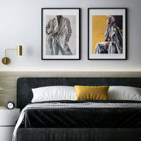 Modern bedroom with a bed, nightstands, and wall art.