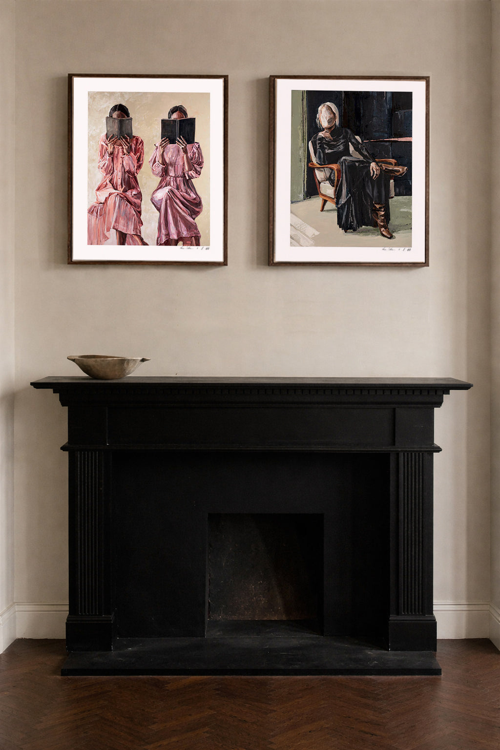 Two framed original figurative art prints of abstract women displayed above black fireplace, available to buy