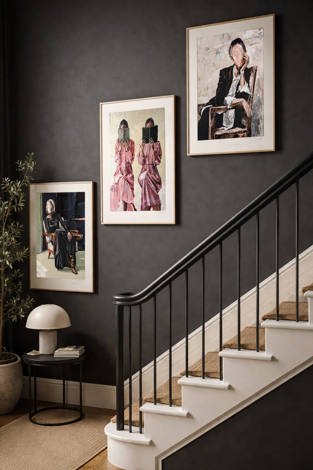 Limited edition set of three original figurative prints ‘Storytelling Trio’ on dark-walled staircase